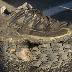 A muddy La Sportiva hiking shoe with "GORE-TEX" branding, indicating its waterproof and breathable meaning for shoes.