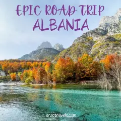 An epic road trip through Albania reveals a stunning turquoise river flowing past a stone house, with mountains and vibrant autumn foliage.