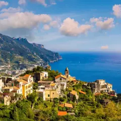 Scenic view of Ravello, Italy, perched on a cliff overlooking the sea. Planning how to get from Naples to Ravello? This picturesque town is worth the journey!