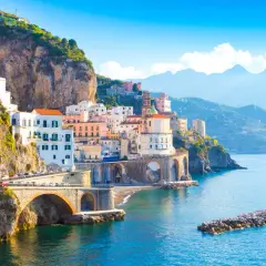 Colorful buildings cling to cliffs overlooking the sea. The Amalfi Coast is safe for exploring this picturesque Italian paradise.