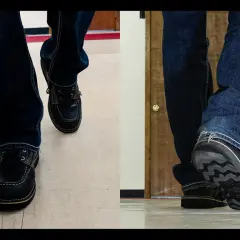 Close-up of feet in jeans and dark shoes. The shoes are made of what looks like real leather, and you can almost hear them squeak with every step.