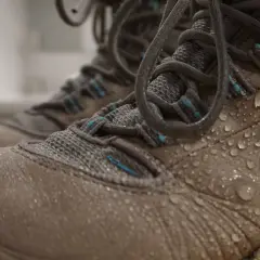 Water droplets on hiking boots. Learn how to clean inside of boots after a muddy adventure.