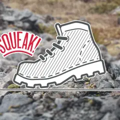 A cartoon boot with laces and a thick sole, with the word "SQUEAK!" in red text above it, on a rocky, blurred background.