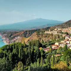 A stunning view of Taormina, Sicily, with Mount Etna in the distance. Perfect for a 14-day Sicily itinerary.