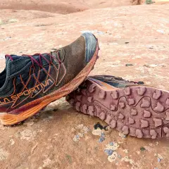 Trail running shoes with synthetic uppers, showing dirt and wear from a rugged adventure. Synthetic uppers are man-made materials, offering durability and water resistance.