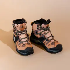 A pair of tan Salomon hiking boots with black accents and laces. These boots are designed for rugged terrain, but how much do hiking boots weigh?
