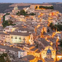 Illuminated Ragusa, Sicily, glows at dusk. Explore its Baroque architecture and charming streets for unforgettable things to do in Ragusa.