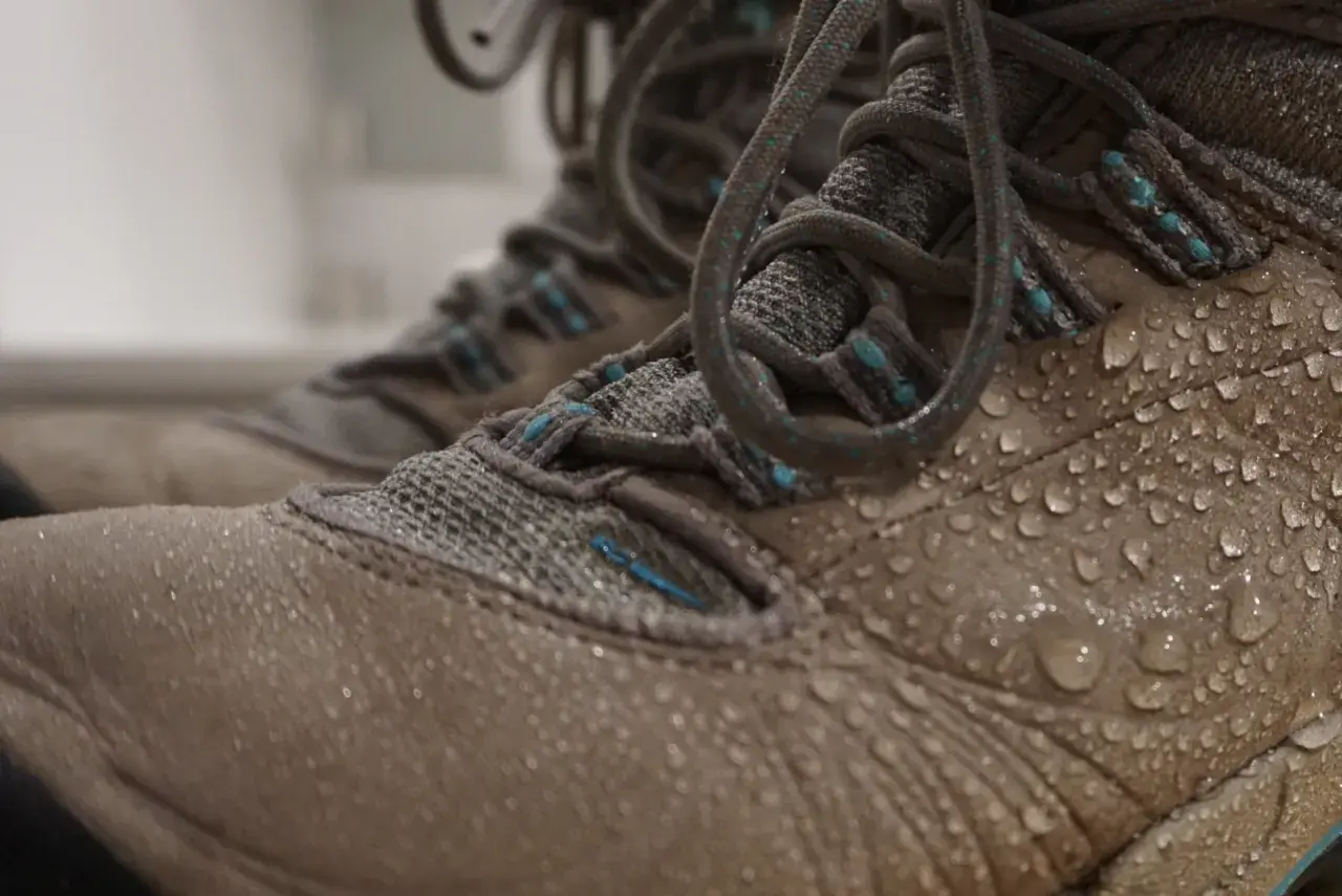 Water droplets on hiking boots. Learn how to clean inside of boots after a muddy adventure.