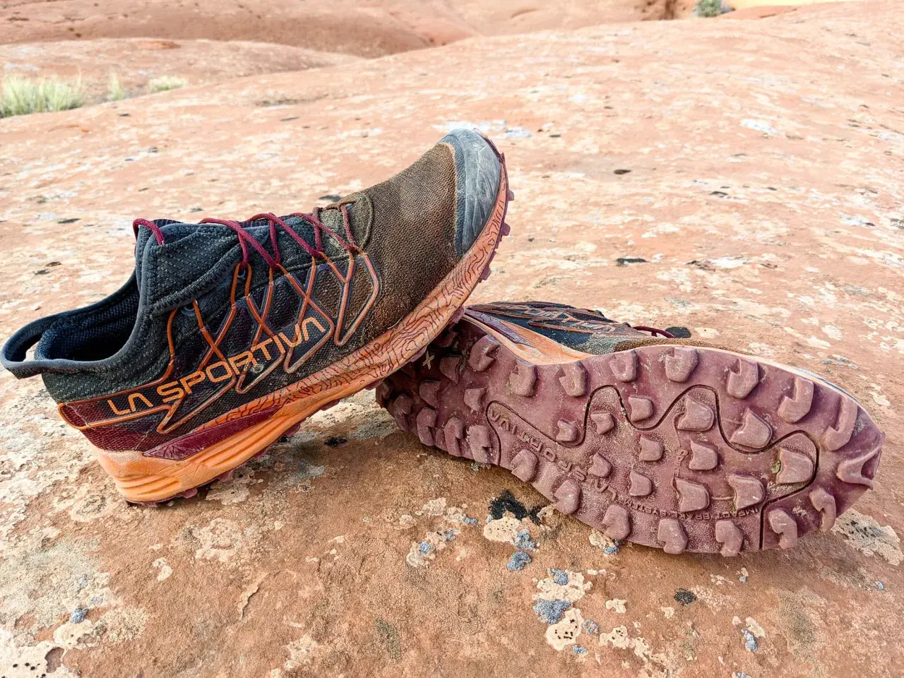 Trail running shoes with synthetic uppers, showing dirt and wear from a rugged adventure. Synthetic uppers are man-made materials, offering durability and water resistance.