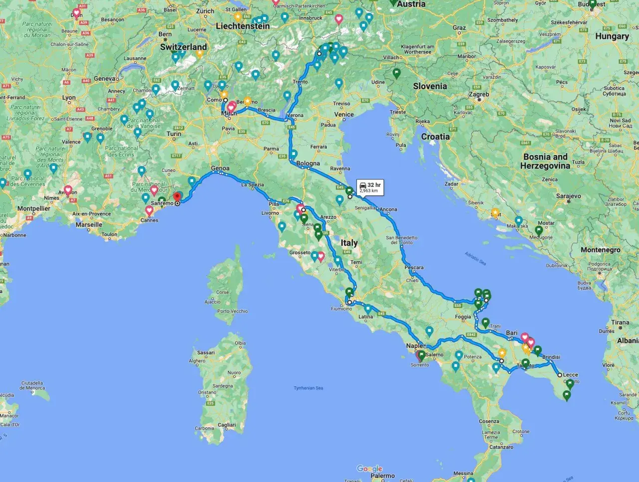A winding blue line traces a scenic Italy road trip route from the French border, through the Alps, down the Italian peninsula, and across to Sicily.