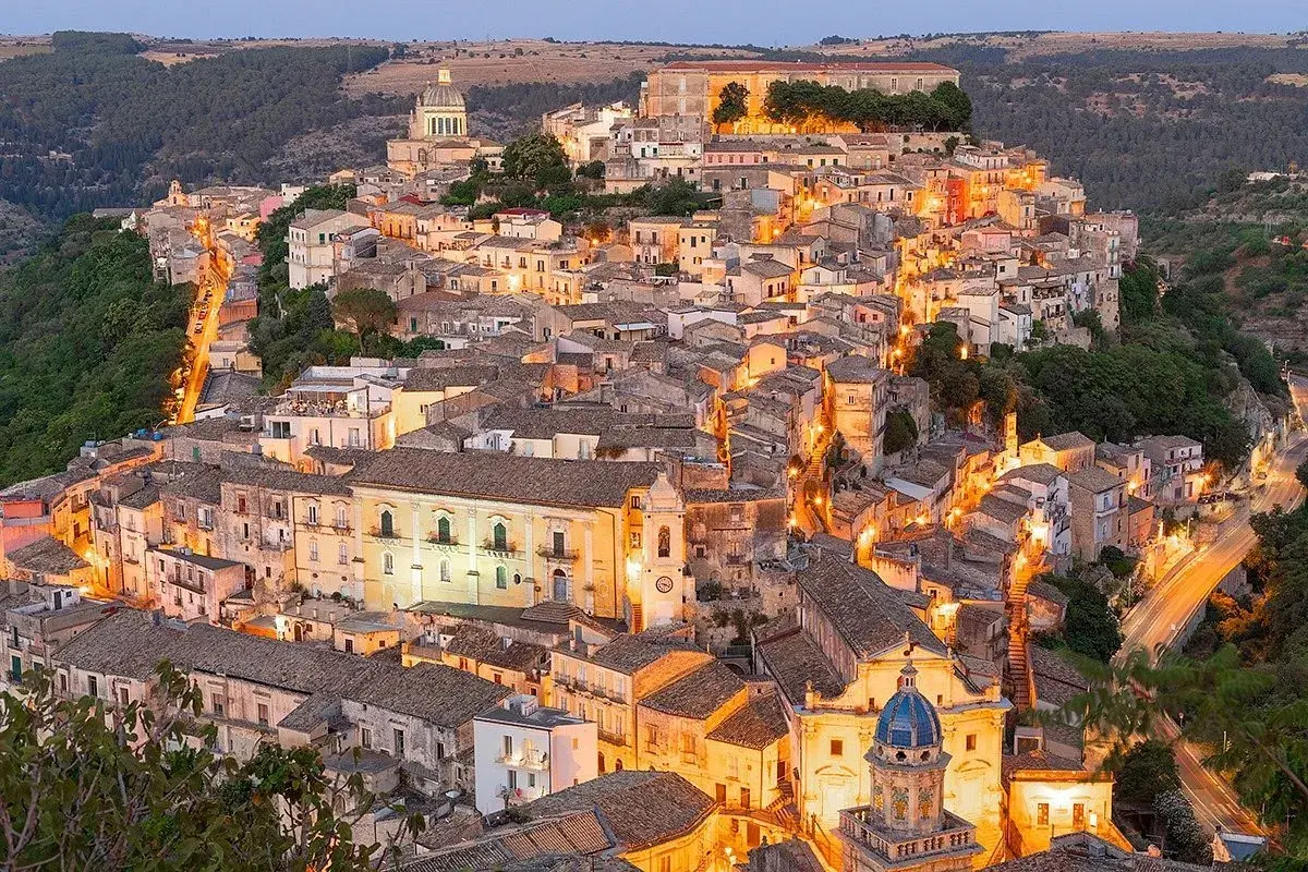 Illuminated Ragusa, Sicily, glows at dusk. Explore its Baroque architecture and charming streets for unforgettable things to do in Ragusa.