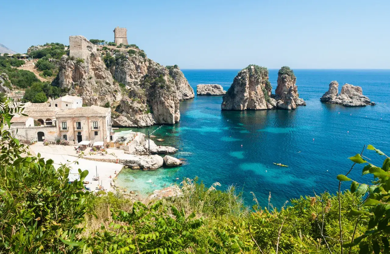 Scopello, Sicily: a picturesque bay with ancient ruins, a charming village, and turquoise waters, perfect for exploring these beautiful places to visit in Sicily.
