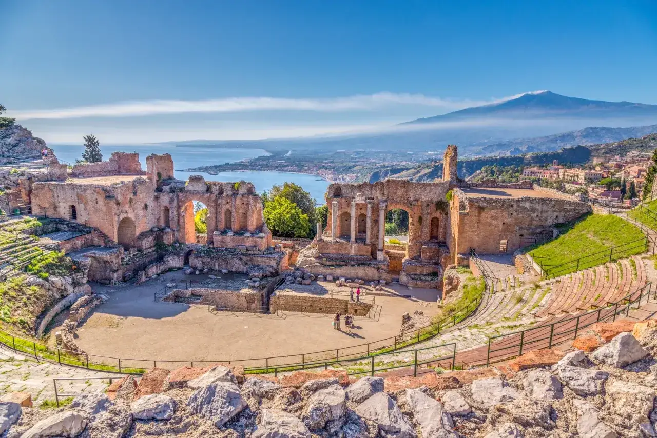 Ancient Greek theatre in Taormina, a must-see among top places to see in Sicily, with Mount Etna in the background.