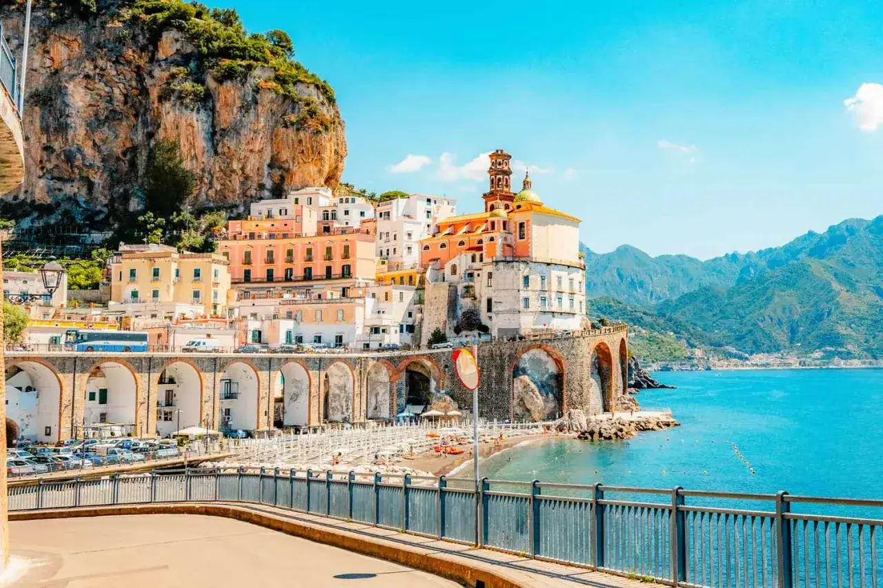 A vibrant view of the Amalfi Coast beaches, with colorful buildings cascading down a cliffside. This scene is a perfect visual for an Amalfi Coast beaches map.