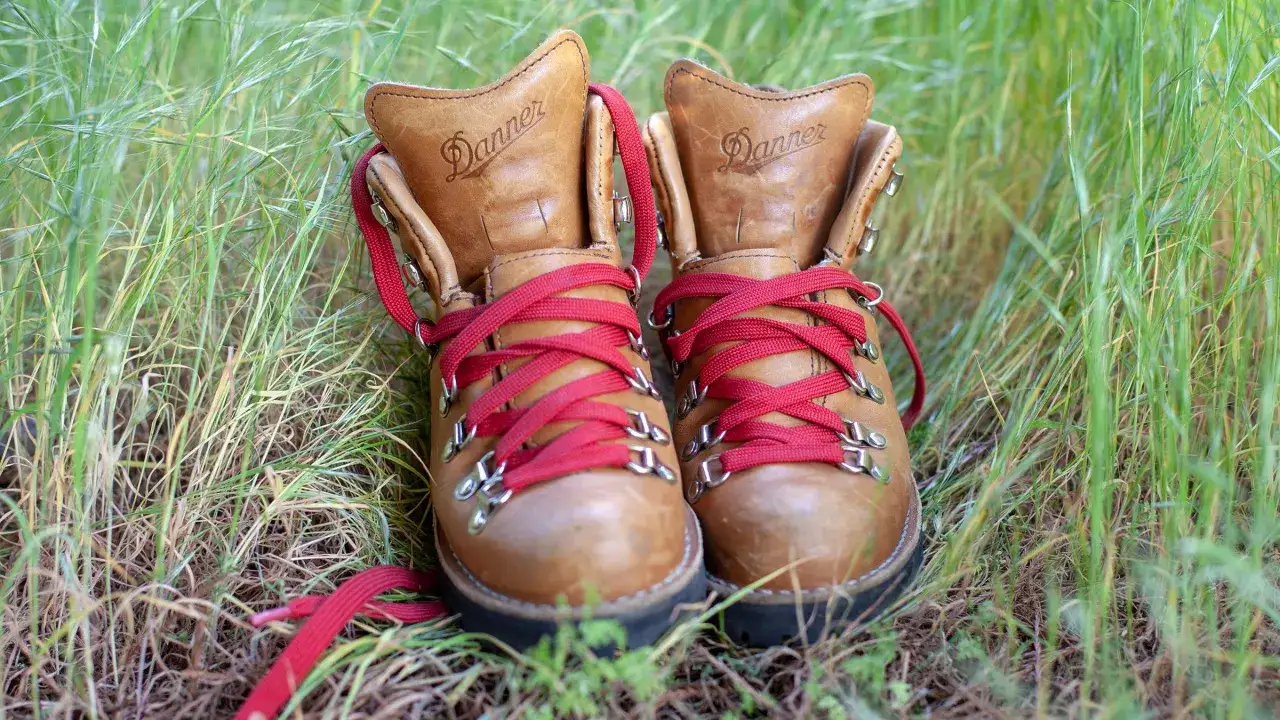 These well-worn Danner leather boots, with their bright red laces, hint at many adventures. Properly cared for, leather boots can last for years, asking how long do leather boots last is a question of care and quality.