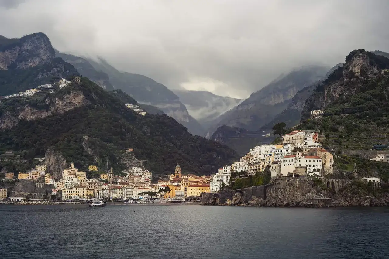 Coastal villages cling to steep mountainsides, a picturesque journey from Naples to Calabria.