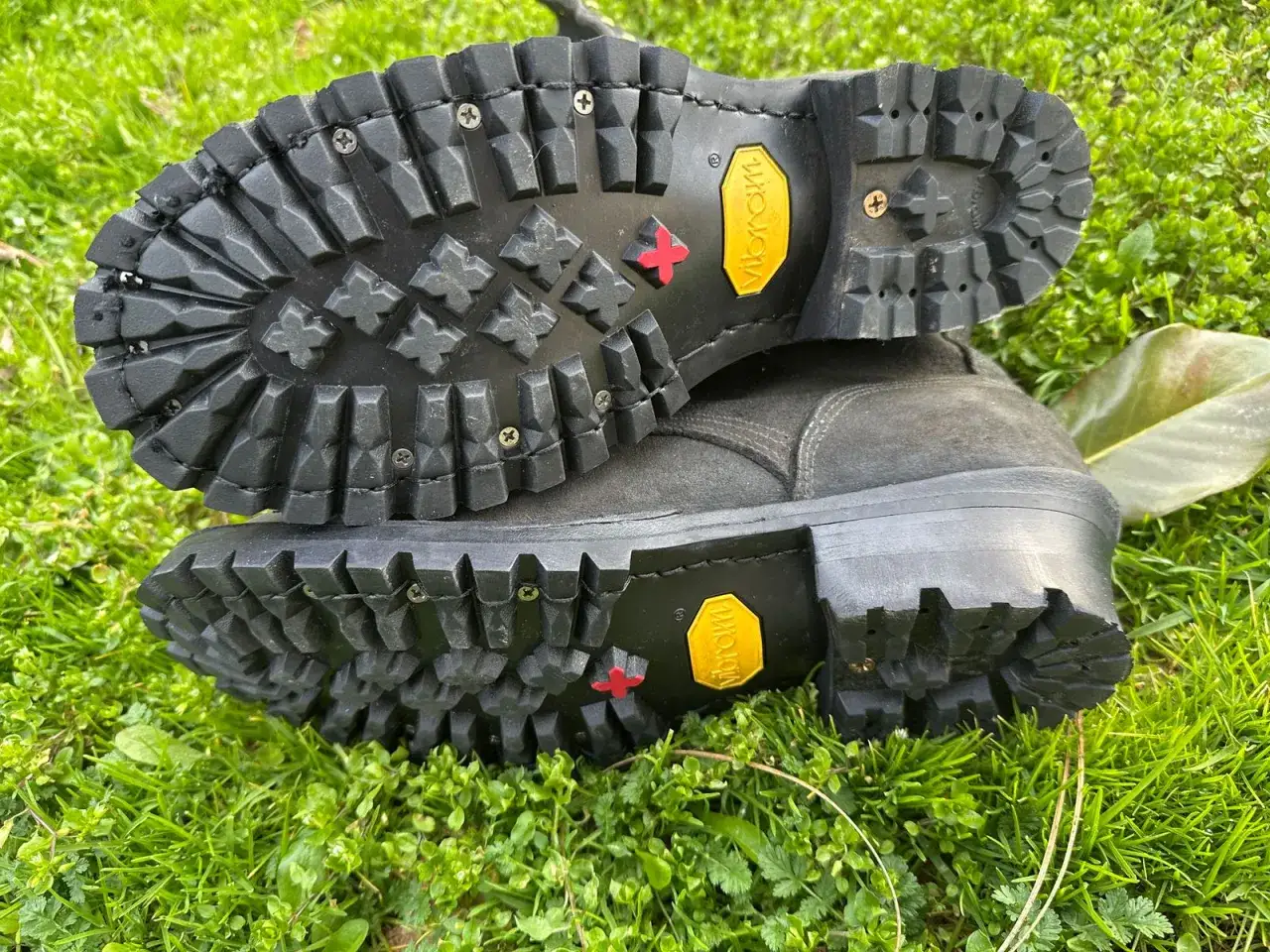 Heavy-duty resole hiking boots with aggressive Vibram soles, ready for any trail.